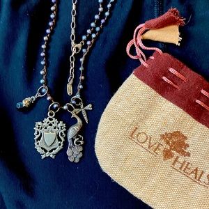 A Love Heals string peacock pearl necklace with 4 Love Heals charms